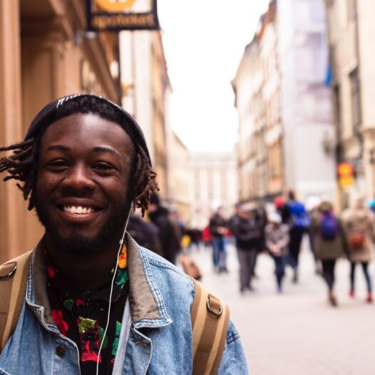selective focus of man smiling near building